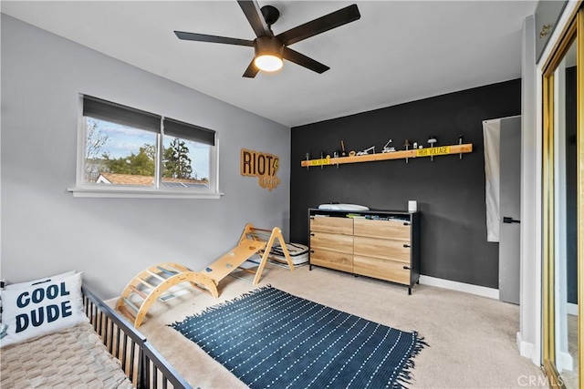 carpeted bedroom with ceiling fan and baseboards