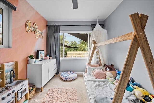 bedroom featuring a ceiling fan and carpet