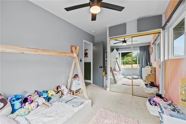 carpeted bedroom featuring a closet and ceiling fan