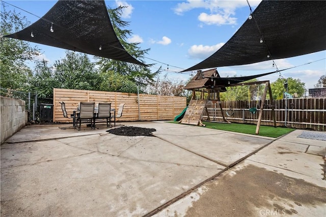 view of patio / terrace featuring a playground and a fenced backyard