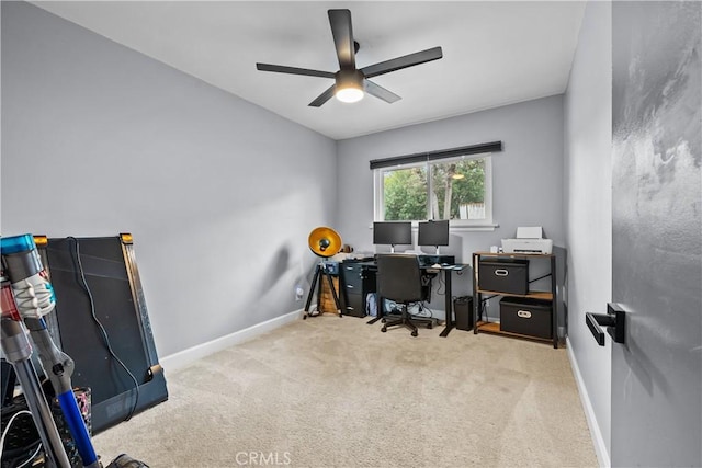 carpeted office featuring baseboards and ceiling fan