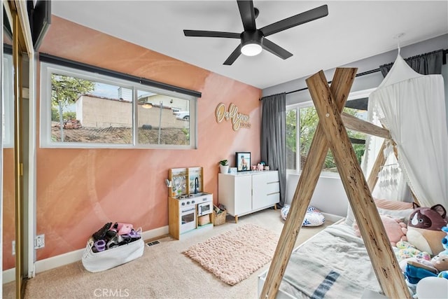 bedroom with ceiling fan, baseboards, and carpet