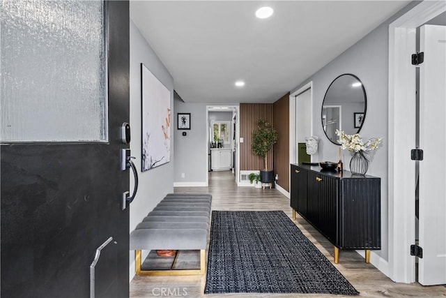 interior space with recessed lighting, wood finished floors, and baseboards