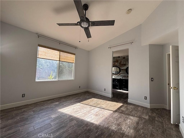 unfurnished bedroom with dark wood finished floors, a ceiling fan, baseboards, and vaulted ceiling