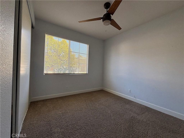 empty room with carpet, baseboards, and ceiling fan