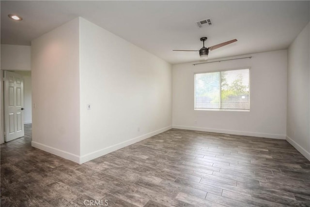 spare room with visible vents, baseboards, a ceiling fan, and wood finished floors