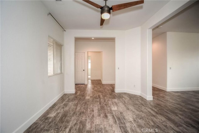 interior space with baseboards and wood finished floors