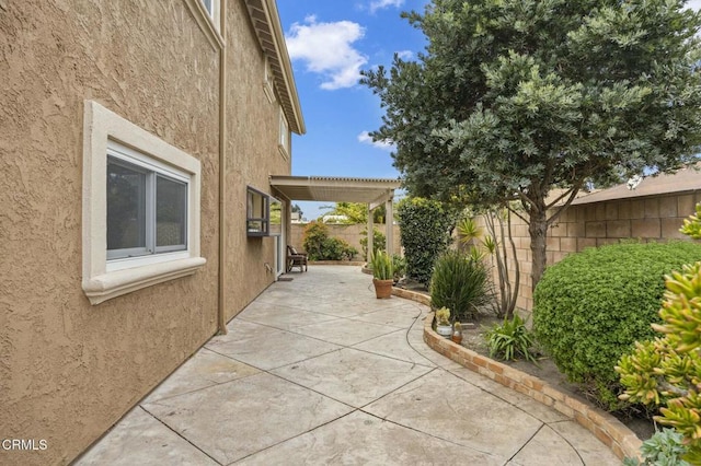 view of home's exterior featuring stucco siding, a patio, and a fenced backyard