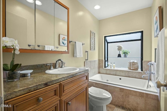 full bathroom featuring a bath, toilet, and vanity