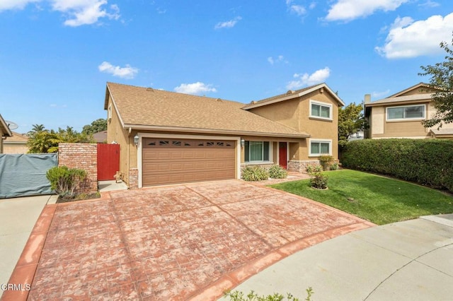 traditional-style home with fence, driveway, an attached garage, stucco siding, and a front lawn