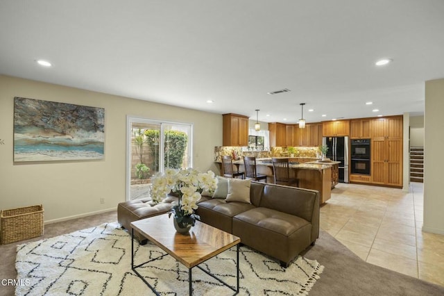 living room with light tile patterned flooring, recessed lighting, visible vents, and baseboards