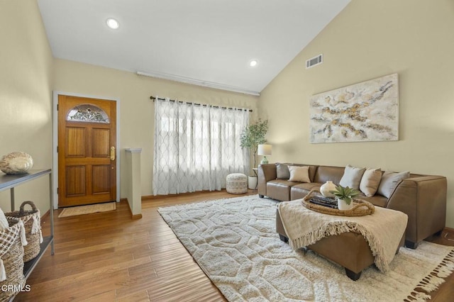 living room featuring recessed lighting, visible vents, high vaulted ceiling, and wood finished floors