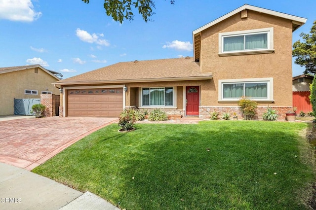 traditional-style home featuring a front yard, fence, stucco siding, a garage, and decorative driveway