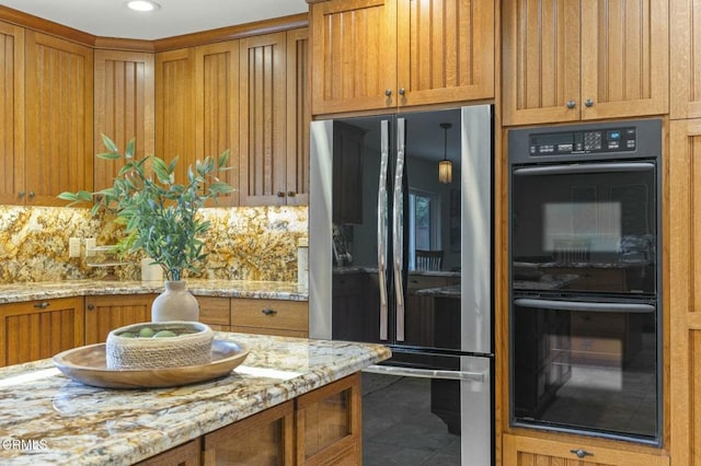 kitchen with light stone countertops, decorative backsplash, smart refrigerator, dobule oven black, and brown cabinets