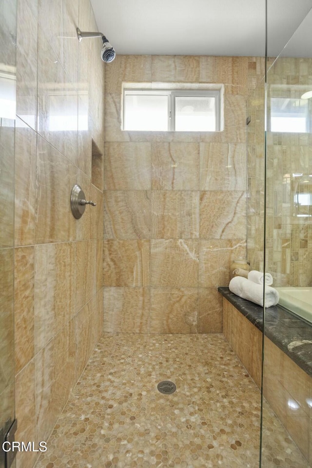 full bath featuring tiled shower