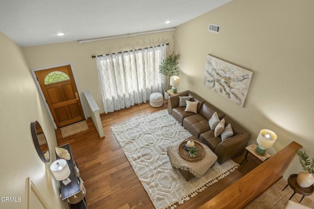 living area with visible vents, recessed lighting, and wood finished floors