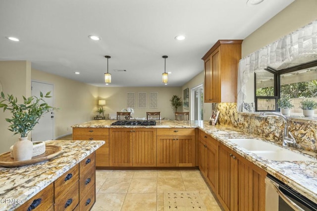 kitchen featuring a sink, dishwashing machine, brown cabinets, and light stone countertops