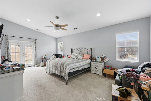 bedroom featuring visible vents, lofted ceiling, light carpet, french doors, and access to outside