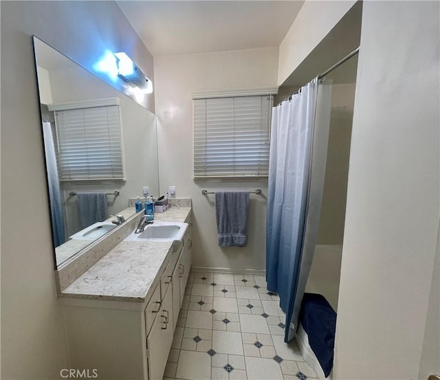 bathroom featuring a shower with shower curtain and vanity