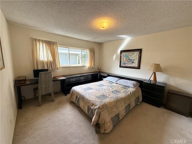 bedroom featuring a textured ceiling and light carpet