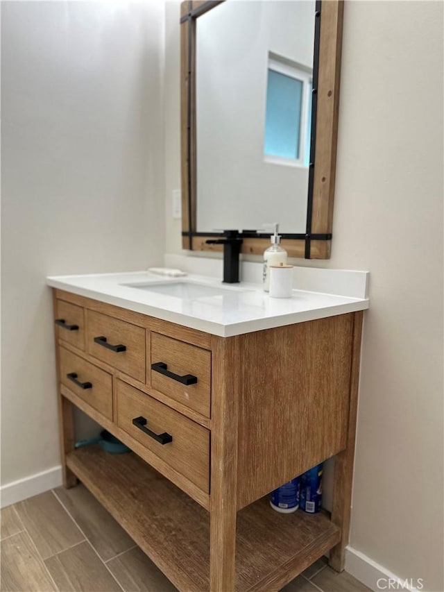 bathroom with vanity and baseboards