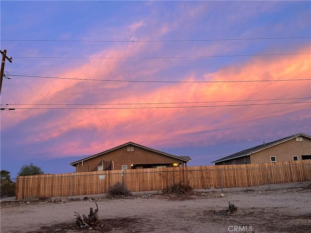 view of home's exterior featuring stucco siding and fence private yard