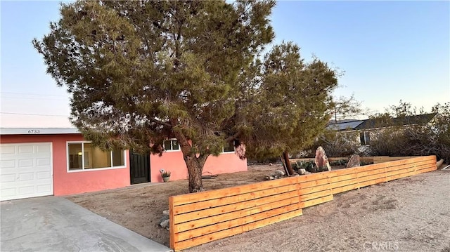 exterior space with fence and a garage