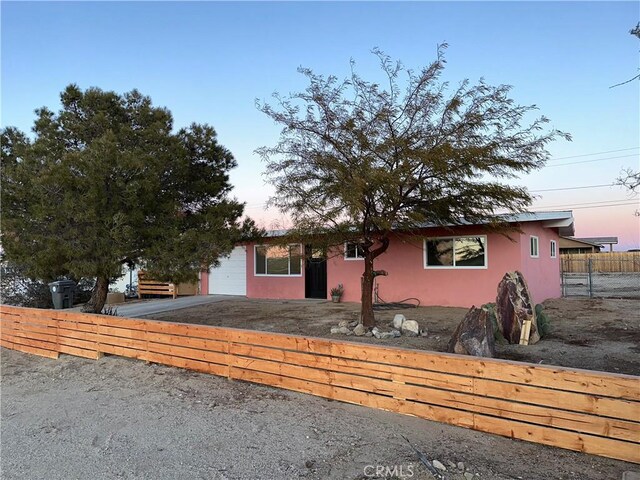 view of front of house featuring a fenced front yard and stucco siding