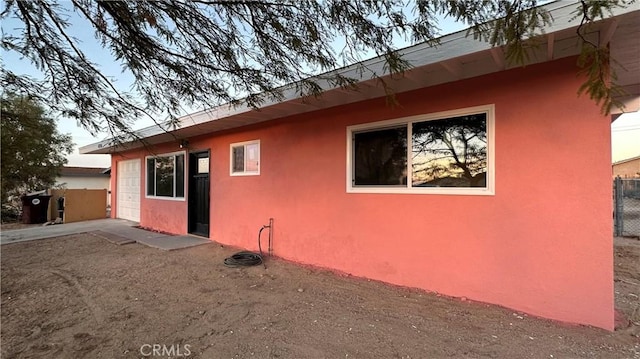 exterior space with fence and stucco siding