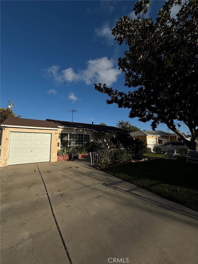 ranch-style house featuring driveway and a garage