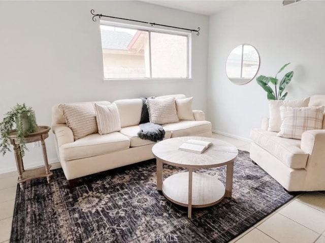 living area featuring tile patterned flooring and baseboards