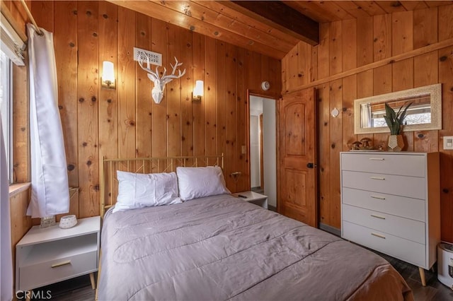 bedroom with wood walls and vaulted ceiling with beams