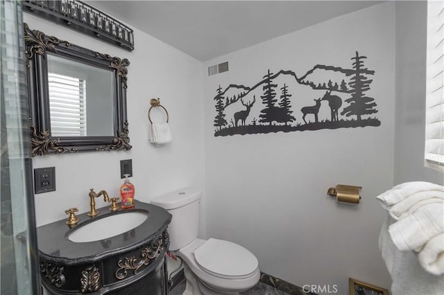 bathroom featuring visible vents, toilet, and vanity