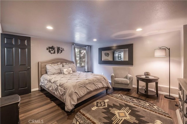 bedroom with recessed lighting, dark wood-style floors, and baseboards