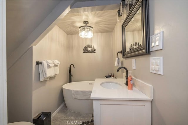 full bathroom featuring a soaking tub, vanity, and baseboards