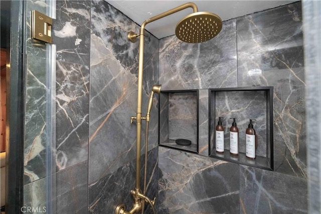 interior details featuring tiled shower