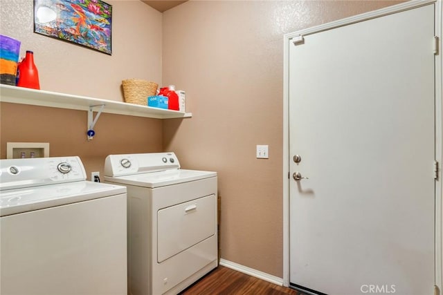 laundry room with washing machine and clothes dryer, laundry area, baseboards, and dark wood-style flooring