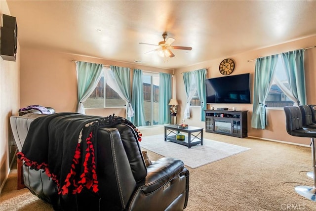 living room featuring a ceiling fan and carpet