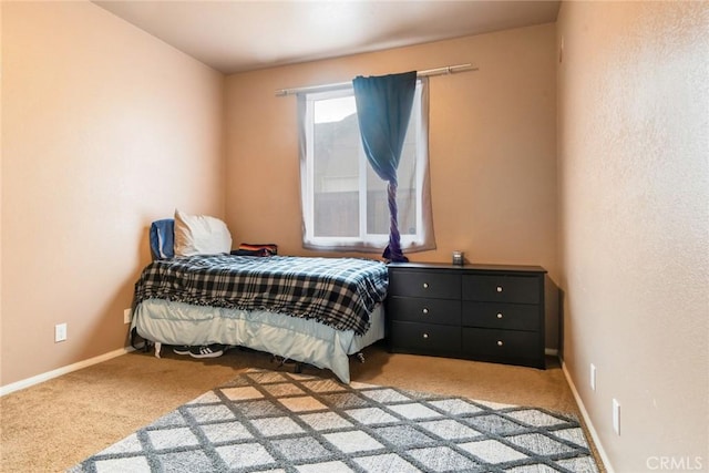 carpeted bedroom with baseboards