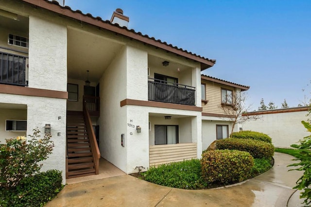 exterior space with stucco siding and stairs