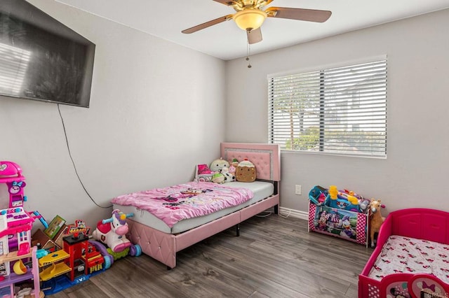 bedroom featuring baseboards, ceiling fan, and wood finished floors