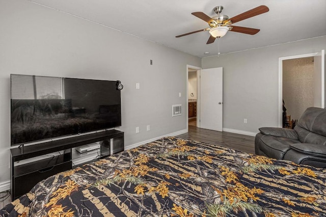 bedroom featuring visible vents, ceiling fan, baseboards, and wood finished floors