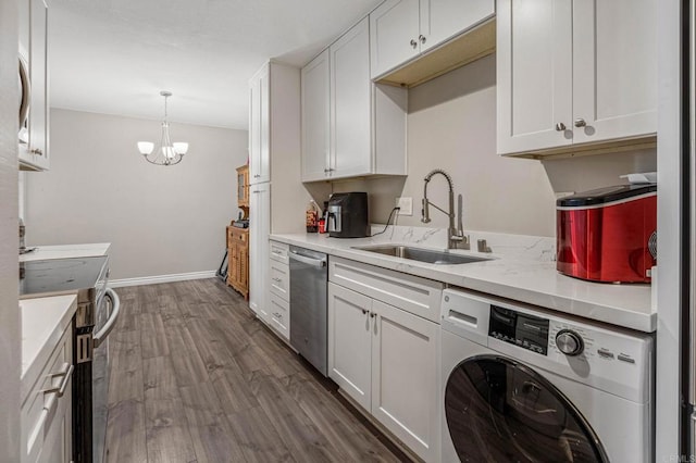 kitchen with dark wood-type flooring, a sink, washer / clothes dryer, stainless steel appliances, and light countertops