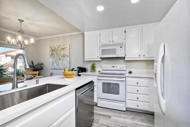 kitchen featuring ornamental molding, a sink, white cabinetry, white appliances, and light countertops