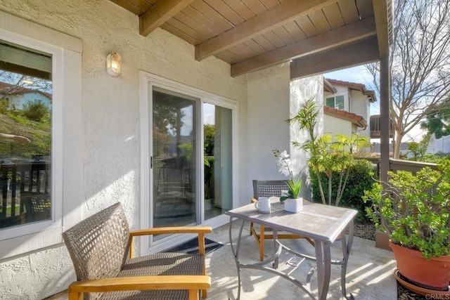 balcony with a patio area and outdoor dining space