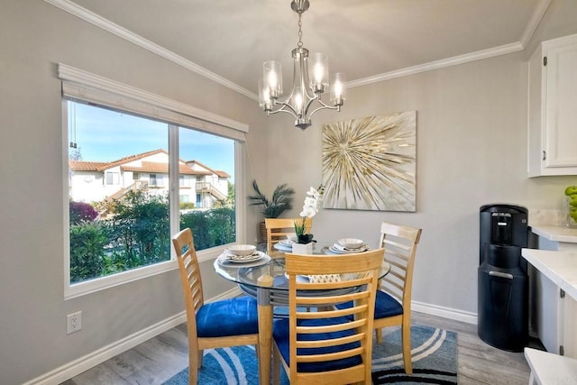 dining space with baseboards, light wood finished floors, and ornamental molding