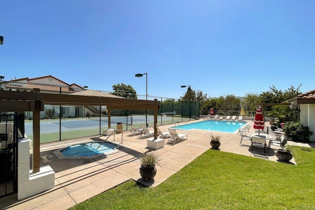 pool with a yard, a patio, a tennis court, and fence