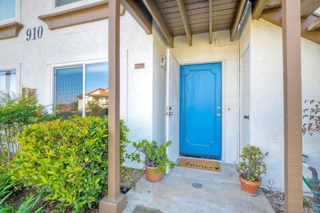 doorway to property with stucco siding