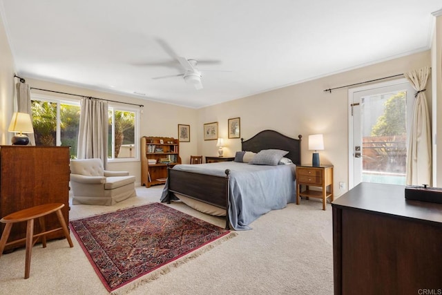 bedroom with a ceiling fan, access to exterior, and light colored carpet