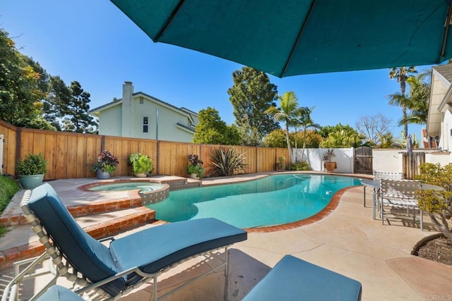 view of pool featuring a pool with connected hot tub, a fenced backyard, and a patio area